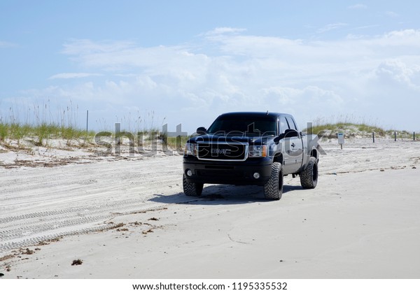 AMELIA ISLAND, FLORIDA, US - OCTOBER 22th, 2017:\
Huge pickup on Amelia island on October 22, 2017. People often come\
by car to the beaches to fishing, take some sunbathe and swim in\
the Atlantic ocean