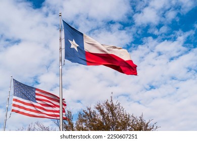 America Flag and Lone Star Texas State Flag waving in the wind over Midland, Texas