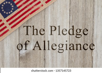 America patriotic message, USA patriotic old flag on a weathered wood background with text The Pledge of Allegiance
