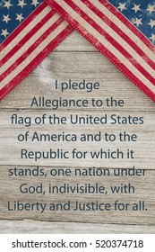 America patriotic message, USA patriotic old flag and weathered wood background with text of the Pledge of Allegiance