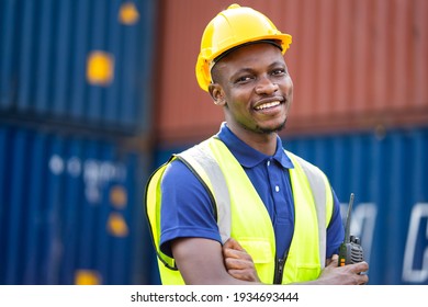 American African engineer or factory worker man at Container cargo harbor to loading containers. African dock male staff for Logistics import export shipping concept.