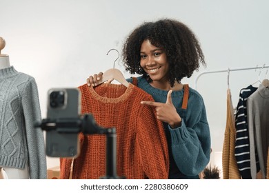 American African entrepreneur smile and use mobile phone to live stream. Successful SME entrepreneur concept - Powered by Shutterstock