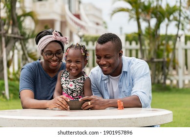 American African Family Watching Photo Selfie Family In Mobile With Smile And Happy In Garden House- American African Family Outdoor Activity Moments