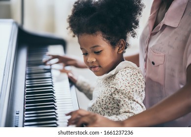 American African Young Pianist, Teacher Teaching Girl Kid Student To Play Piano, Art Of Music Education Concept