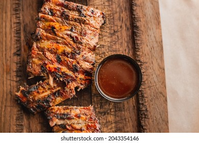 American Barbecue Meat. Delicious Bbq Ribs Cut On Wooden Desk. Grilled Ribeye Steak Meat . Griling Season Meat Serving, Closeup. Steakhouse Dinner.