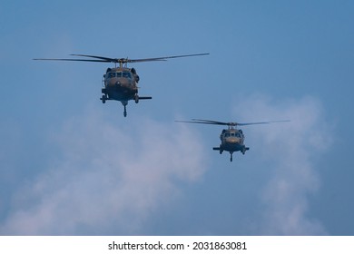 American Black Hawk Helicopter Sikorsky UH - 60M Attack Takes Off At The Operation With Weapons Between Smoke In Battle War On The Blue Sky