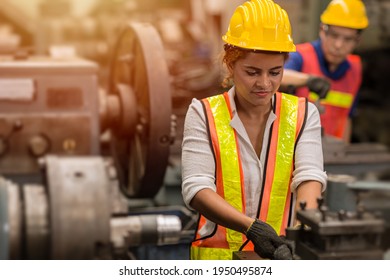 American Black Women Teen Worker Working Part Time Job As Labor In Industry Factory With Heavy Steel Machine.