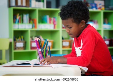 American boy make home wore and drawing in preschool library, education, kid, and school concept - Powered by Shutterstock