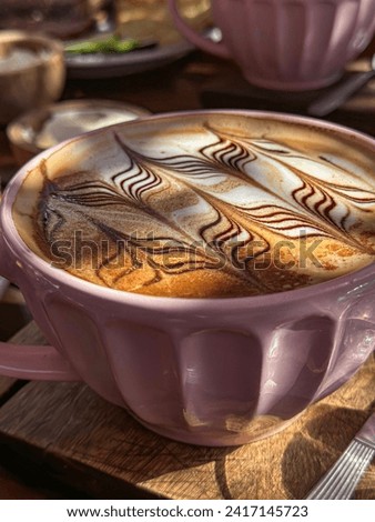 American breakfast, close-up of large cup of cappuccino coffee. Professional barista craftsman. Coffee decoration.