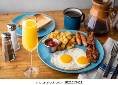 American Breakfast With Mimosa On Wooden Table Top