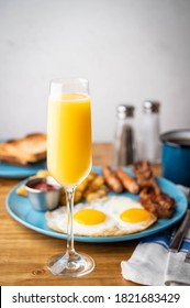 American Breakfast With Mimosa On Wooden Table Top