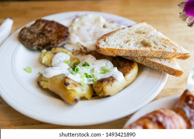 American Breakfast With Sausage Patty, Sourdough Bread Toast, Fried Egg, And Potatoes, Top View