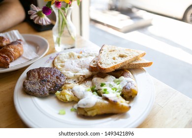 American Breakfast With Sausage Patty, Sourdough Bread Toast, Fried Egg, And Potatoes, Top View