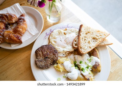 American Breakfast With Sausage Patty, Sourdough Bread Toast, Fried Egg, And Potatoes, Top View