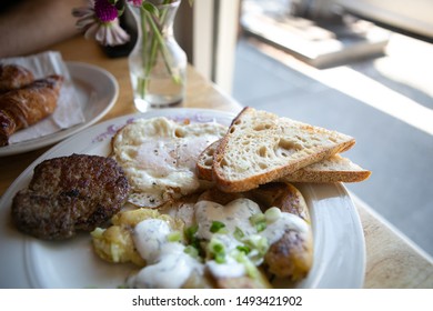 American Breakfast With Sausage Patty, Sourdough Bread Toast, Fried Egg, And Potatoes, Top View