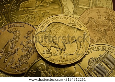 American Buffalo Gold Coin on stack of other gold coins, American Eagle