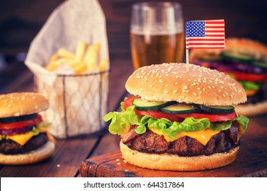 American Burger with bacon,cheese,tomato,lettuce and french fries at a Picnic for 4th of July 
