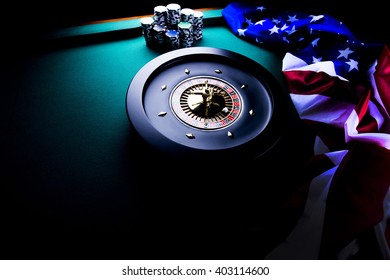 american casino theme, high contrast image of casino roulette, playing chips and american flag