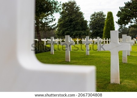 American cemetery at Omaha Beach, looking at the white grave crosses and an out of focus cross in the foreground