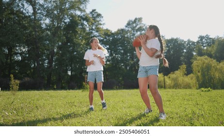 American children playing ball. American football sports concept. American football with children playing in a park. American football player and his children playing football in lifestyle park. - Powered by Shutterstock