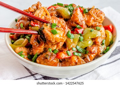 American Chinese Cuisine, Sweet And Sour Chicken In A Bowl With Chopsticks, Close Up And High Angle Photo. Asian Food Photography.