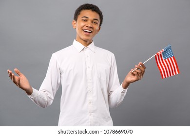 American Citizen. Joyful Nice Man Smiling While Holding The US Flag