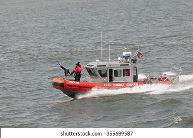 AMERICAN COAST GUARD VESSEL UNDERWAY NEW YORK - CIRCA  2013 - US Coast Guard Patrol Boat With Officer Manning Gun On The Bow Patrolling On New York Harbor NY USA