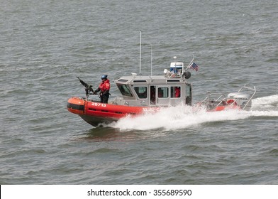 AMERICAN COAST GUARD VESSEL UNDERWAY NEW YORK - CIRCA  2013 - US Coast Guard Patrol Boat With Officer Manning Gun On The Bow Patrolling On New York Harbor NY USA