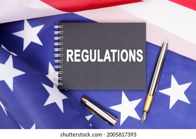 American concept. The US flag has a pen and a notebook with the inscription - REGULATIONS - Powered by Shutterstock