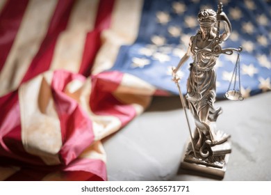 American constitution, law and legal system, statue of lady justice with scales of justice with american flag background - Powered by Shutterstock