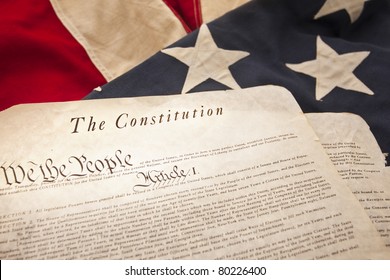 The American Constitution On A Flag Background (Selective Focus)