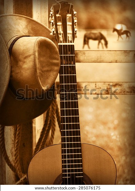 American country music background with cowboy hat\
and guitar