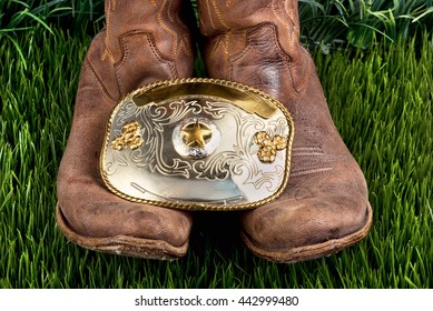 American cowboy with his boots and big silver cowboy belt buckle.