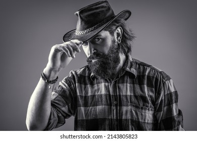 American cowboy. Leather Cowboy Hat. Portrait of young man wearing cowboy hat. Cowboys in hat. Handsome bearded macho. Black and white.