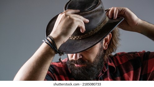 American cowboy. Leather Cowboy Hat. Portrait of young man wearing cowboy hat. Cowboys in hat. Handsome bearded macho.