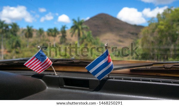 American and Cuban flags inside a\
car. Conceptual image for their relationship.\
Cuba.