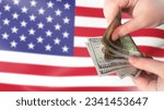 American currency. Dollars in hands. US money. Man counts money. US flag. Financial relations in America. USD payment. United states money. Paper banknotes of dollars. Currency USD.