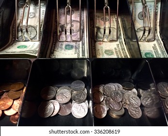 American dallar notes and coins inside the cash register machine