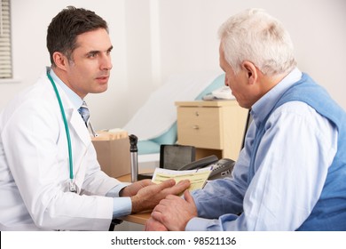 American Doctor Talking To Senior Man In Surgery