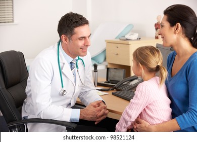 American doctor talking to young child and mother