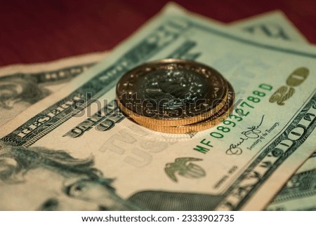 American dollar bills and Mexican peso coins