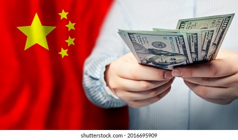 American Dollars Cash Money In Hand Against Flag Of China