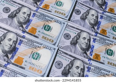 American dollars in hundreds of bills lined up on a table. - Shutterstock ID 2294141855