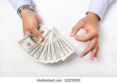 American Dollars in a man hands on a gray background and a symbol OK make with the fingers.