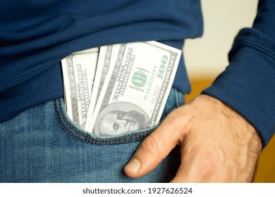 American Dollars Are Peeking Out Of Jeans Pocket. American Rescue Plan, USA Relief Program, Stimulus Check, Act Of 2021 Concept. Money, Business, Profit And Livelihood Idea