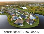 American dream homes at evening on rural cul-de-sac street in US suburbs. View from above of waterfront residential houses in living area in North Port, Florida