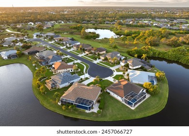 American dream homes at evening on rural cul-de-sac street in US suburbs. View from above of waterfront residential houses in living area in North Port, Florida