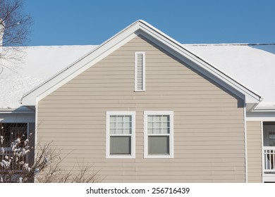 American Dream House In The Suburban Village With Snow Covered The Roof In Winter Season, Located In USA