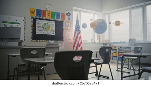 American Elementary School: Interior of Empty Classroom with Desks for Students, Chalkboard, Solar System Models and Colorful Posters. Educational and Inspiring Learning Environment for Children.