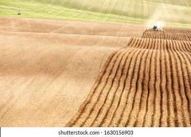 American Falls, Idaho, USA Apr. 17, 2015 Farmer Using A Tractor And Plowing Implement Prepares A Field For Potato Planting In The Fertile Farm Fields Of Idaho.